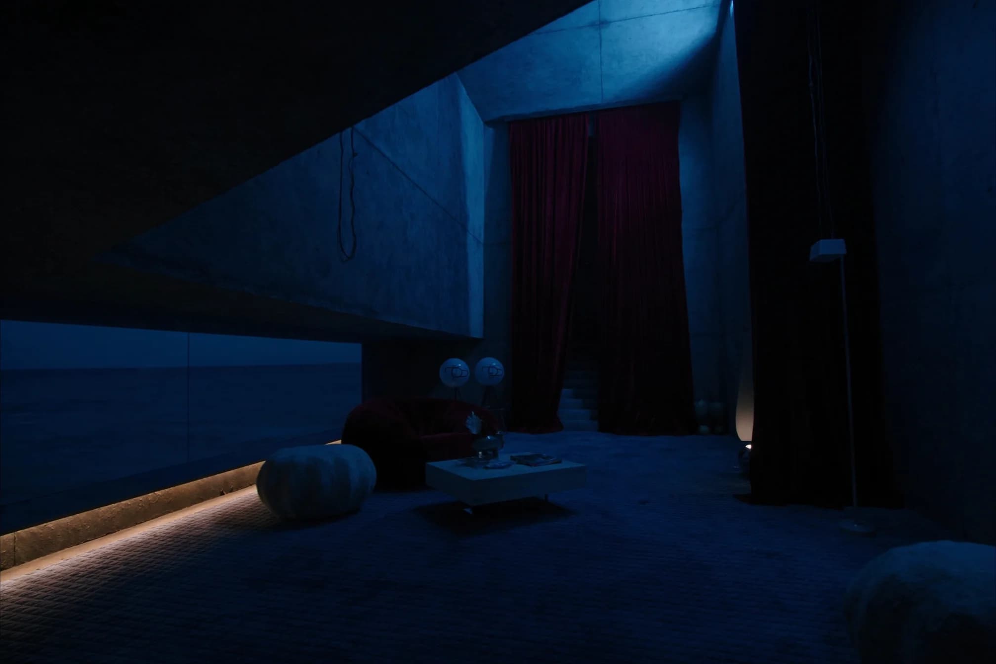 Brutalist seaside hotel lounge at blue hour with floor-to-ceiling burgundy curtains